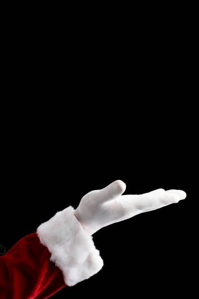 istock Santa Claus hand presenting isolated on black background. 879652506