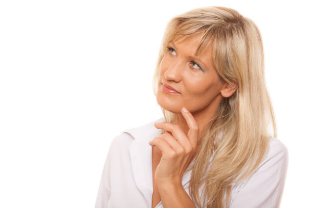 istock Thinking mature woman looking up isolated 879656188