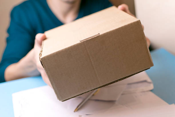 istock The man gives a parcel to the post office. Mail. 879656230