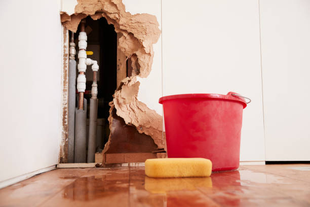 Damaged wall, exposed burst water pipes, sponge and bucket Damaged wall, exposed burst water pipes, sponge and bucket damaged stock pictures, royalty-free photos & images