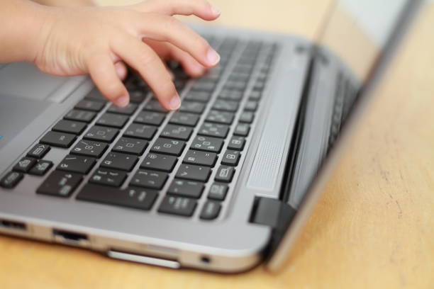 istock hands of Japanese girl using notebook PC (3 years old) 879660516
