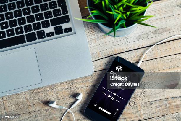Mobile Phone Placed On A Wooden Desk With Podcast App In The Screen Stock Photo - Download Image Now