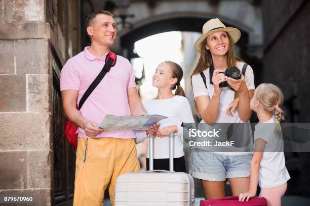 Smiling Parents With Children Walking With Map And Camera Stock Photo - Download Image Now