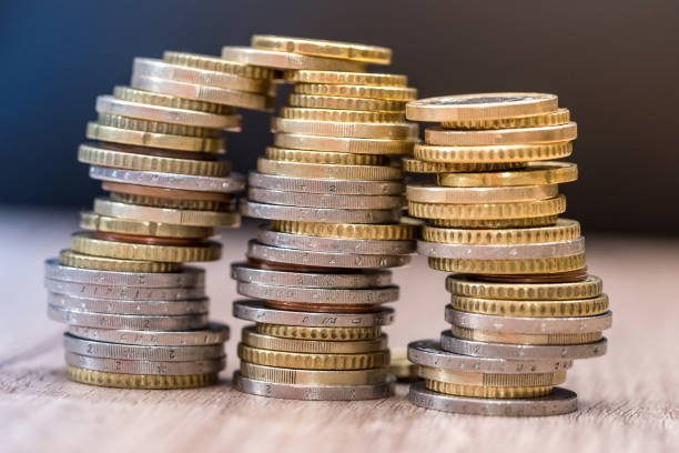 istock euro coins in a pile at table. close up 879671762