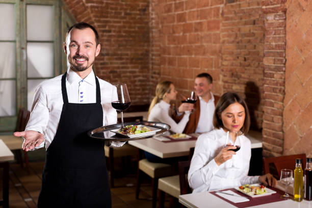 istock Waiter showing country restaurant to visitors 879672170
