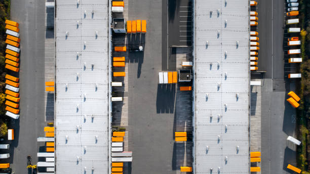 Distribution logistics building parking lot - aerial view Distribution logistics building parking lot - aerial view industrial orange stock pictures, royalty-free photos & images