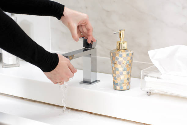 young woman washing her hands - water human hand stream clean imagens e fotografias de stock