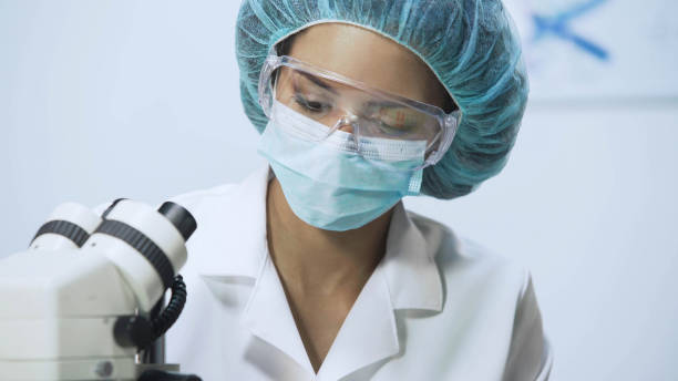 istock Lab researcher working on microscope at university laboratory, close-up 879689142