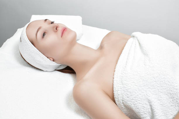 istock woman getting facial mask in spa 879689482