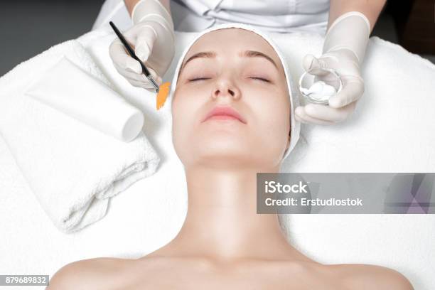 Beautician Applies Mask To The Face Of Woman Stock Photo - Download Image Now - Peel - Plant Part, Skin, Facial Mask - Beauty Product