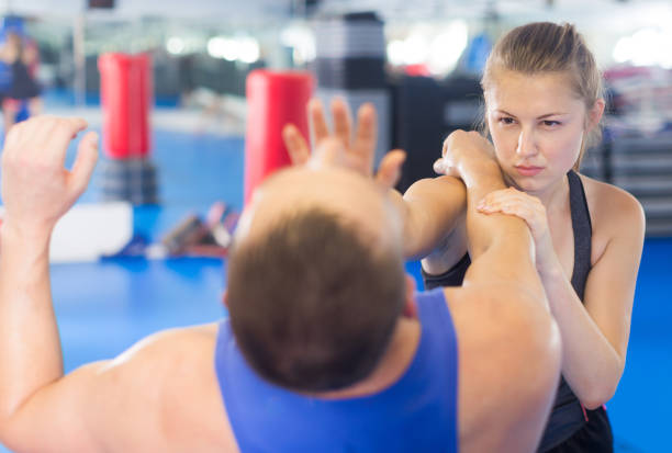 istock Nice woman is fighting with trainer 879695702