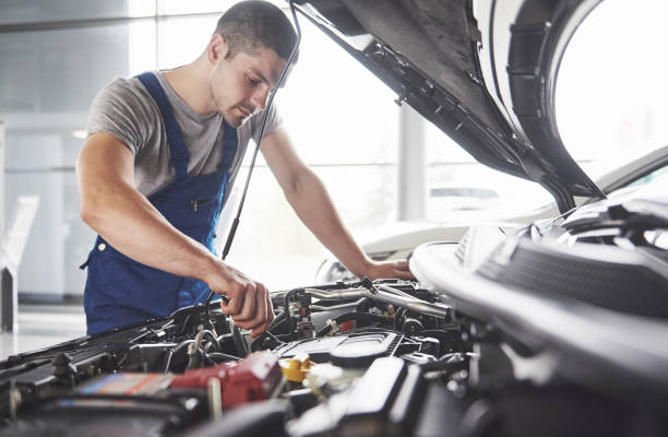istock Auto mechanic working in garage. Repair service 879696180