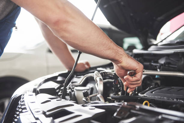 Auto mechanic working in garage. Repair service Close up hands of unrecognizable mechanic doing car service and maintenance. engine stock pictures, royalty-free photos & images