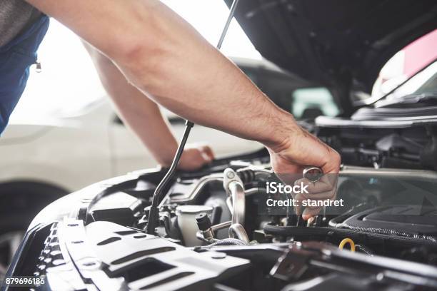 Auto Mechanic Working In Garage Repair Service Stock Photo - Download Image Now - Car, Mechanic, Repairing