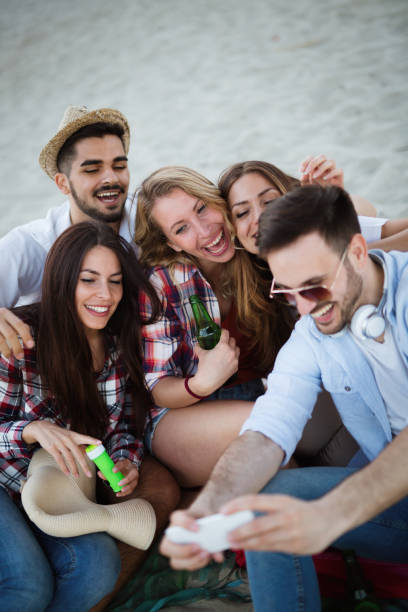 istock Happy young group of people taking selfies on beach 879696282
