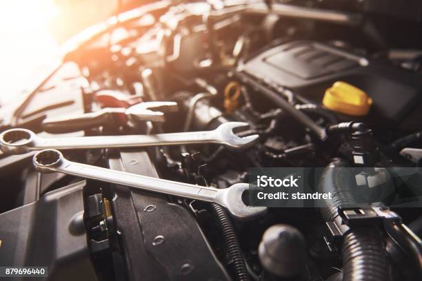 Mechanic Hand Checking And Fixing A Broken Car In Car Service Garage Stock Photo - Download Image Now