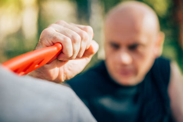 istock Knife threat. Kapap instructor demonstrates self defense knife threat disarming 879696838
