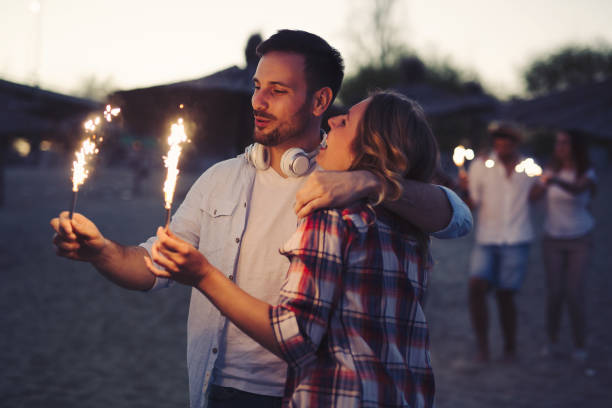 istock Group of happy friends having fun on beach at night 879696898