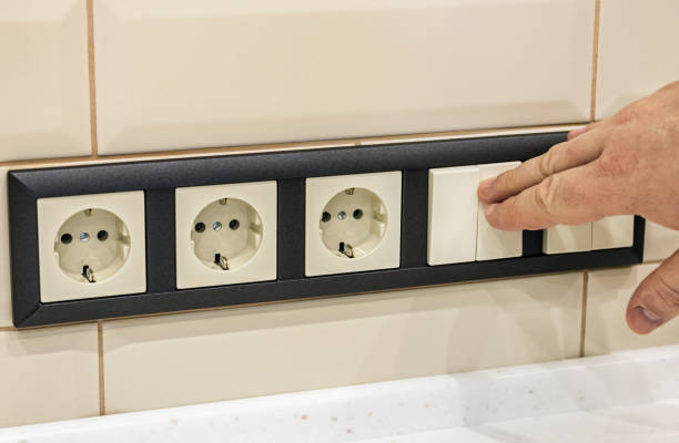 istock hand disables or enables the electricity in the room 879701654