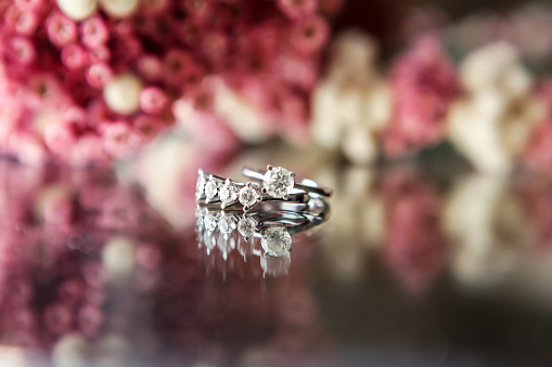 Diamond rings, wedding ring, engagement ring, flowered background