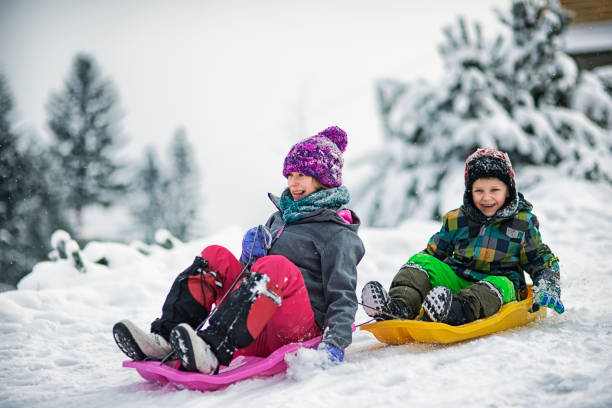 istock Children sledding in winter. 879714288