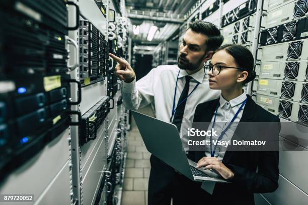 Handsome Man And Attractive Woman Are Working In Data Centre Stock Photo - Download Image Now