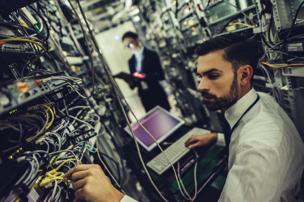 istock Handsome man and attractive woman are working in data centre 879720286
