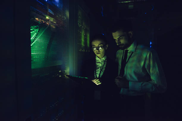 istock Handsome man and attractive woman are working in data centre 879720346