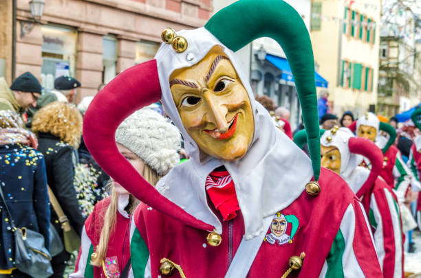 Traditionally, the festive and cultural carnival procession through the streets of cities and towns in German Germany, Lahr - JANUARY 17: Participants in costumes perform a street procession Carneval Fasnacht January 17, 2016 in the city of Lahr, Germany. Traditionally, the festive and cultural carnival procession through the streets of cities and towns in Germany fastnacht stock pictures, royalty-free photos & images