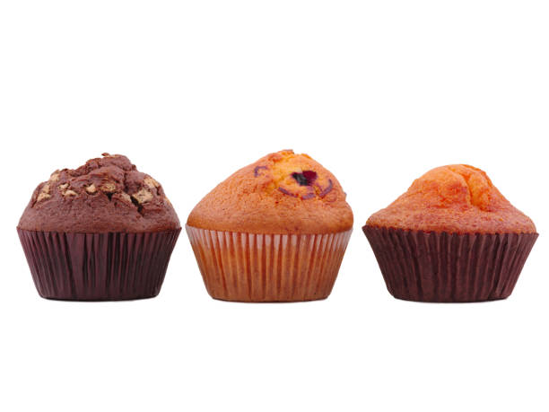 istock Three different cupcakes, in the middle with jam on a white isolated background 879723292