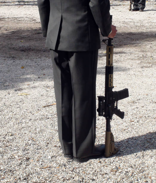 istock Military Officer Holding Gun 879726024