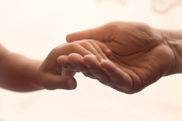 mani di vecchi e giovani - holding hands human hand child mother foto e immagini stock