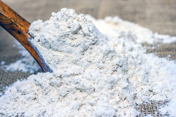 istock Wheat flour in wooden scoop. 879726260