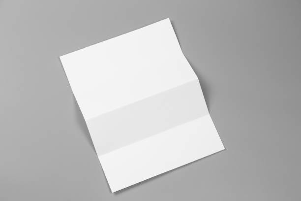 istock Blank portrait A4. brochure magazine isolated on gray, changeable background / white paper isolated on gray 879726704