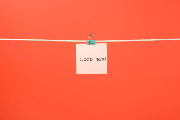 istock Pink paper sheet on the string with text Good Job over colorful background 879735788