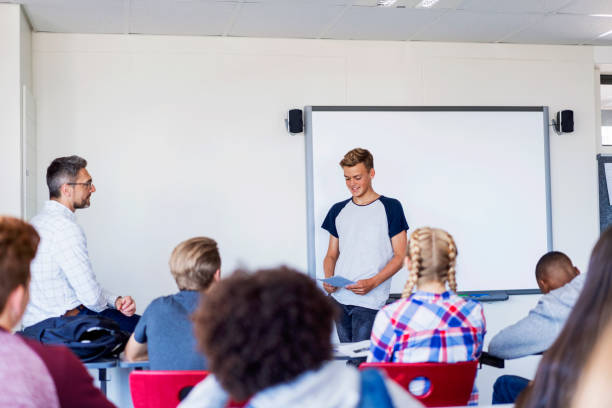 istock Confident teenage boy giving presentation 879741574