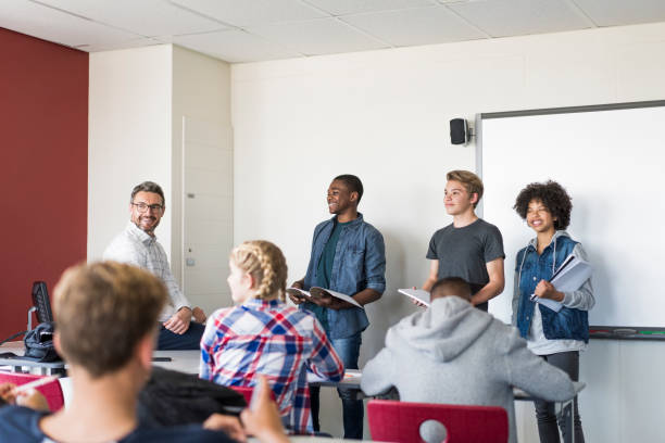 istock Multi-ethnic teenage students giving presentation 879741666