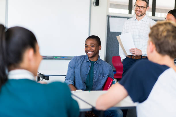 istock Smiling multi-ethnic teenagers at classroom 879746348