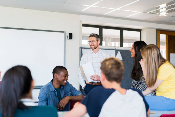 istock Happy professor and teenage students in classroom 879746474
