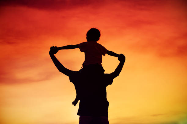istock father and son play on sunset sky 879751312