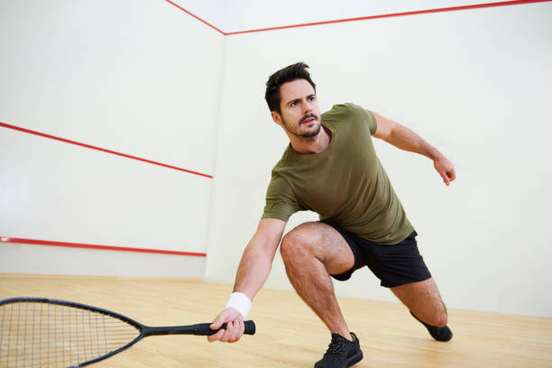 man during squash match on court - squash racketball sport exercising imagens e fotografias de stock