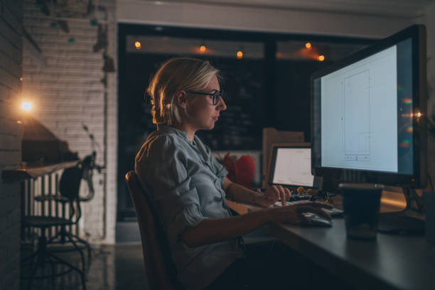 istock Young woman working late 879752710