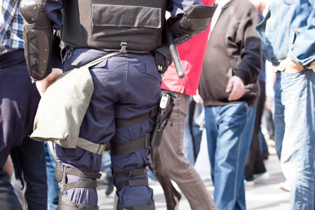 istock Police officer on duty during a street protest 879754608