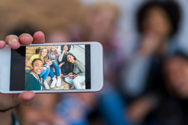 istock Happy female students on smart phone display 879759790