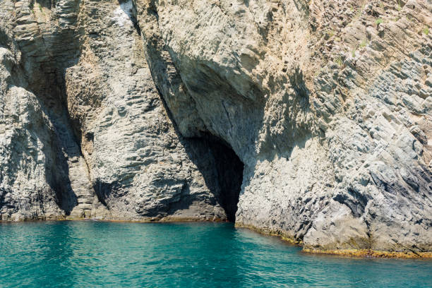 istock The mountain with cave above the water 879763474
