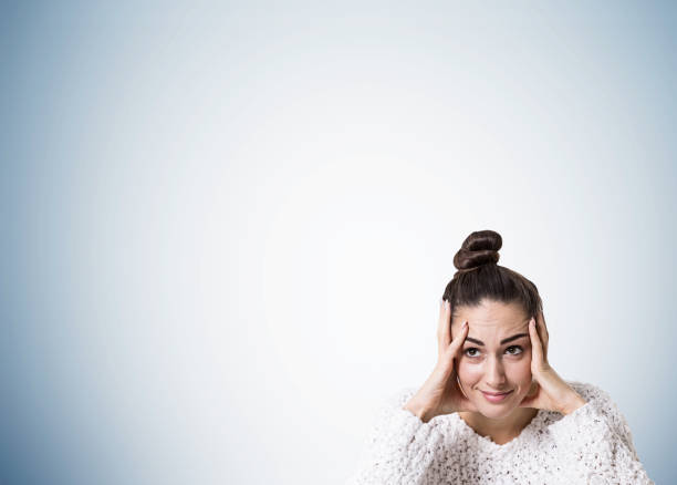 istock Stressed young woman with a bun, gray 879765736