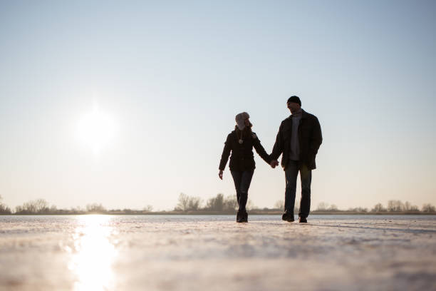 istock Smiling love couple walking hand in hand 879767246
