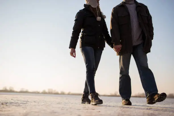 Cropped image a love couple walking hand in hand