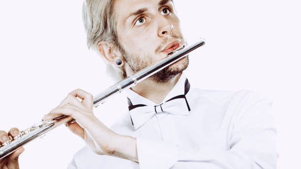 istock Male flutist playing his flute 879769704