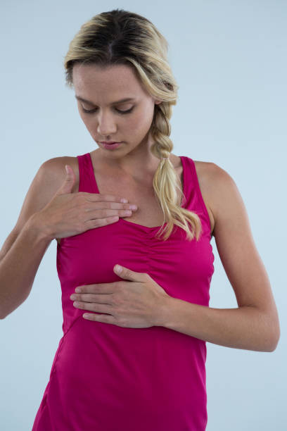 istock Woman examining breast for lumps 879770400